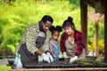 Portrait of African man and wife teaching the children to plant seedlings in greenhouse Royalty Free Stock Photo