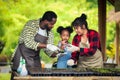 Portrait of African man and wife teaching the children to plant seedlings in greenhouse Royalty Free Stock Photo
