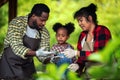 Portrait of African man and wife teaching the children to plant seedlings in greenhouse Royalty Free Stock Photo