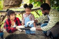 Portrait of African man and wife teaching the children to plant seedlings in greenhouse Royalty Free Stock Photo