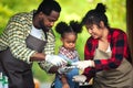 Portrait of African man and wife teaching the children to plant seedlings in greenhouse Royalty Free Stock Photo