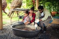 Portrait of African man and wife teaching the children to plant seedlings in greenhouse Royalty Free Stock Photo