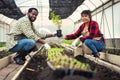 Portrait of African man and wife teaching the children to plant seedlings in greenhouse Royalty Free Stock Photo