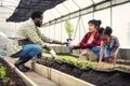 Portrait of African man and wife teaching the children to plant seedlings in greenhouse Royalty Free Stock Photo