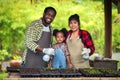 Portrait of African man and wife teaching the children to plant seedlings in greenhouse Royalty Free Stock Photo