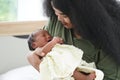 Portrait of African mom carrying adorable newborn baby in her arm. Happy lovely African American family mother and son Royalty Free Stock Photo