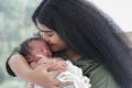 Portrait of African mom carrying and kiss adorable newborn baby in her arm. Happy lovely African American family mother and son Royalty Free Stock Photo