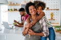 Portrait of african mother hugging with her daughter, enjoying moment of love, having fun together Royalty Free Stock Photo