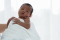 Portrait of African newborn baby boy wrapped in a blanket sleeping on motherÃ¢â¬â¢s hands on white background Royalty Free Stock Photo