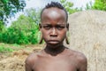 Portrait of African Teenager with a big traditional wooden earrings in the local Mursi tribe village
