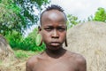 Portrait of African Teenager with a big traditional wooden earrings in the local Mursi tribe village Royalty Free Stock Photo