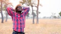 Portrait of african traveler smiling and enjoying his recreation time in nature.Concept of tourism day