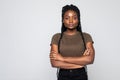 Portrait of african woman with arms folded standing over gray background Royalty Free Stock Photo