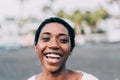 Portrait of african woman outdoor - Happy black female laughing in front of the camera - Real people photography concept - Focus Royalty Free Stock Photo