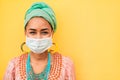 Portrait of african young woman wearing face protective mask - Happy girl wearing bohemian clothes during coronavirus outbreak -