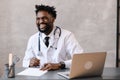 Portrait of afro american doctor using laptop computer. online consultation Royalty Free Stock Photo