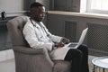 Portrait of afro american doctor using laptop computer. online consultation Royalty Free Stock Photo