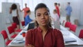 Serious afro woman posing camera office. Businesswoman standing meeting room Royalty Free Stock Photo