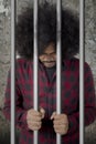 Afro man looks desperate in the jail