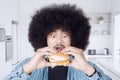 Afro man eating big cheeseburger Royalty Free Stock Photo