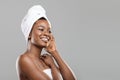 Portrait of afro woman with towel on head and perfect skin