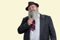 Portrait of aged bearded man singing with microphone. Royalty Free Stock Photo