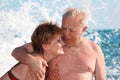 Portrait of aged pair in sea surf