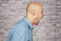 Portrait aggressive bald angry Man boss, screaming at subordinate on brick wall white background Royalty Free Stock Photo