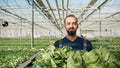 Portrait of agricultural grower man working in greenhouse