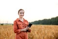 Portrait Agronomist farmer with digital tablet computer in wheat field.