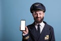 Portrait of airplane pilot showing phone with blank white screen