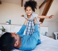 Portrait, airplane and smile of girl child with father in bedroom flying for fantasy, happiness, and fun in modern