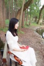 Portrait of Aisan Chinese girl woman student read in nature outdoor garden park play violin over sunset musican