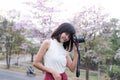 Portrait Alone Woman happy smile and holding Camera photography on blur flower