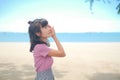 Portrait alone woman standing at coast on blur blue sea and blue sky