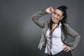 Portrait of alternative woman dressed in formal suit with cheerful and smiling attitude,