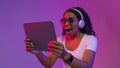 Portrait Of Amazed Black Female Using Digital Tablet In Neon Light Royalty Free Stock Photo