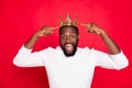 Portrait of amazed crazy afro american beard man point at his crown scream wow omg win prom party competition become