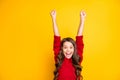 Portrait of amazed excited child raise fists scream wow omg celebrate wear style stylish jumper isolated over yellow