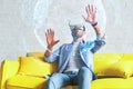 Portrait of amazed excited man watching virtual reality glasses, touching hologram