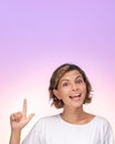 Portrait of Amazed Girl in T-shirt With Finger Pointing Up in Studio Royalty Free Stock Photo