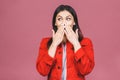 Portrait of amazed shocked young woman isolated over pink background Royalty Free Stock Photo