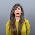 Portrait of a amazed woman against gray background Royalty Free Stock Photo