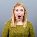 Portrait of a amazed woman against gray background Royalty Free Stock Photo