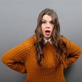 Portrait of a amazed woman against gray background Royalty Free Stock Photo