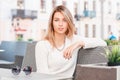 Portrait of an amazing joyful young woman with blue eyes with a sweet smile and blond hair with natural make-up