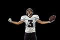 Portrait of American football player equipment helmet and gloves isolated on dark studio background. Concept of sport Royalty Free Stock Photo