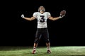 Portrait of American football player equipment helmet and gloves isolated on dark studio background. Concept of sport Royalty Free Stock Photo