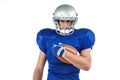 Portrait of American football player holding ball Royalty Free Stock Photo