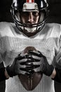 Portrait of american football player holding a ball